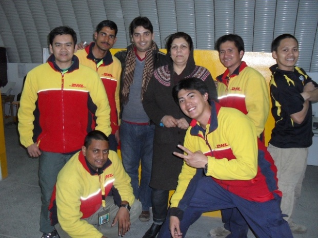 British Afghan Women's Society Director Zarghona Rassa and Driver Sameer pose with DHL crew during pickup of donated relief supplies at Bagram Airfield, Afghanistan Image: DHL-OIAX